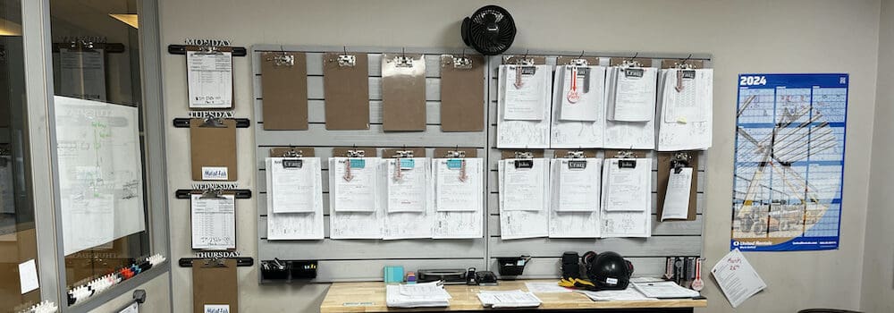clipboards hanging in the office at metalfab industries